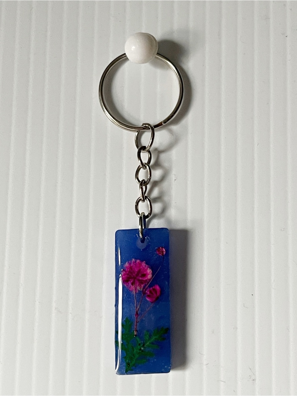 Blue Resin Keychain with Pink Flower NWOT